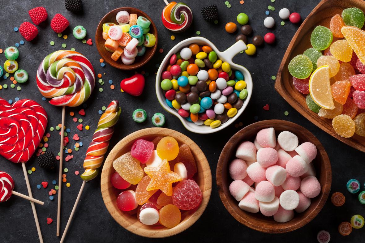 Colorful types of candy on a wooden table