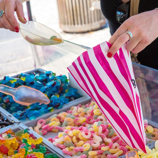 womans hand scooping candy