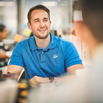 An ADM associate sits at a table talking 