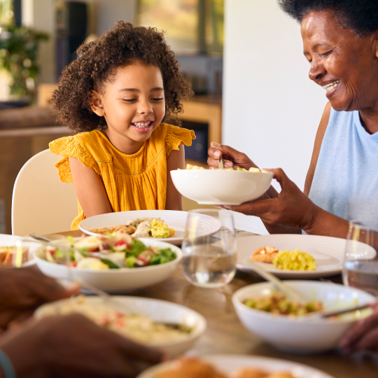 grandmother and child at dinner table