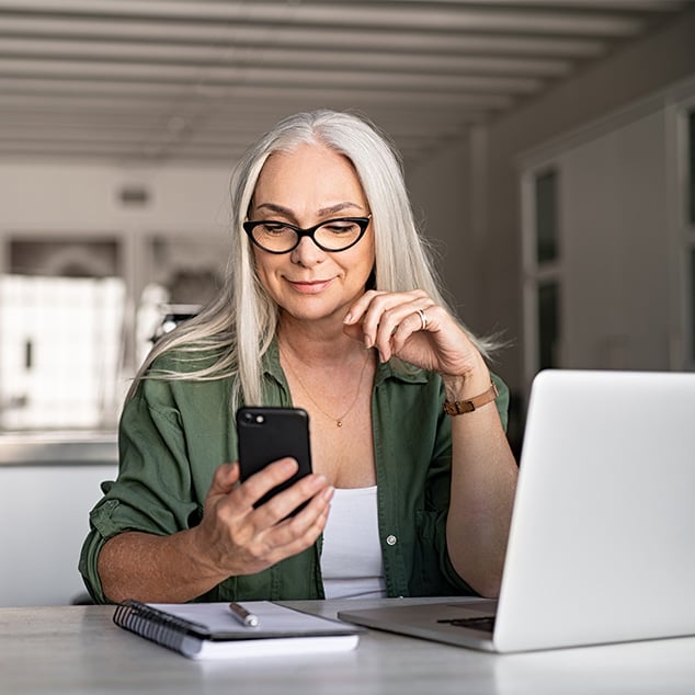 Woman at home looking at her cellphone