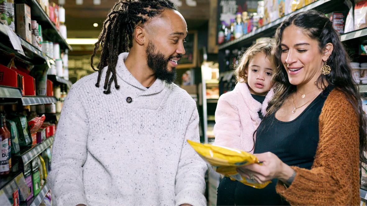 A family of three in a grocery store