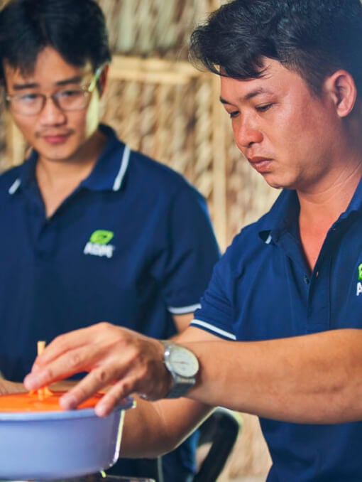 Two ADM employees working at an aquaculture nursery