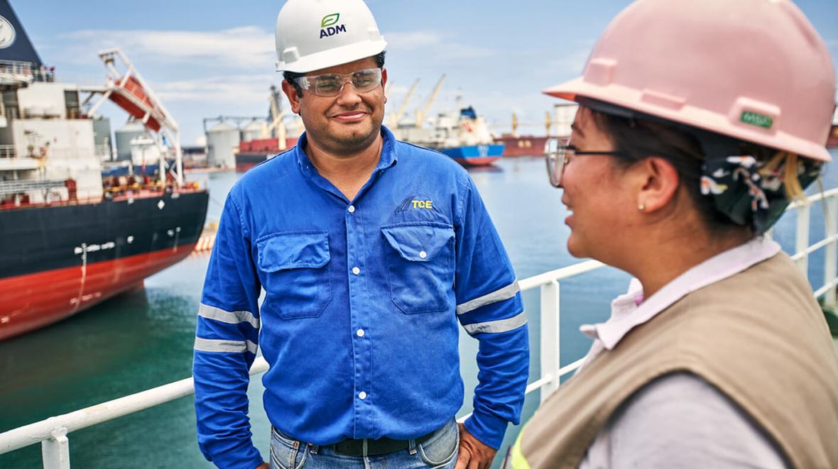 Two ADM employees talking on a shipping dock