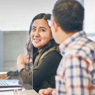 Two people interacting in an office setting 