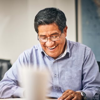 A person smiling in an office setting