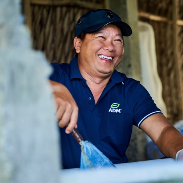 An ADM employee smiling