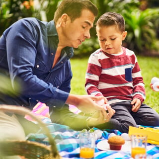 A person and a child having a picnic outside
