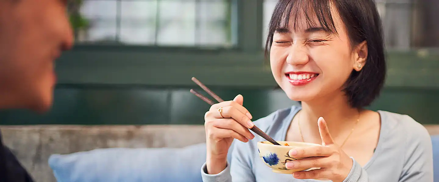 asian woman eating rice bowl