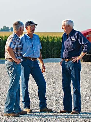 adm com hero men talking in front of tractors 20110721 blueston 149 2021 12 v1 hires mobile image