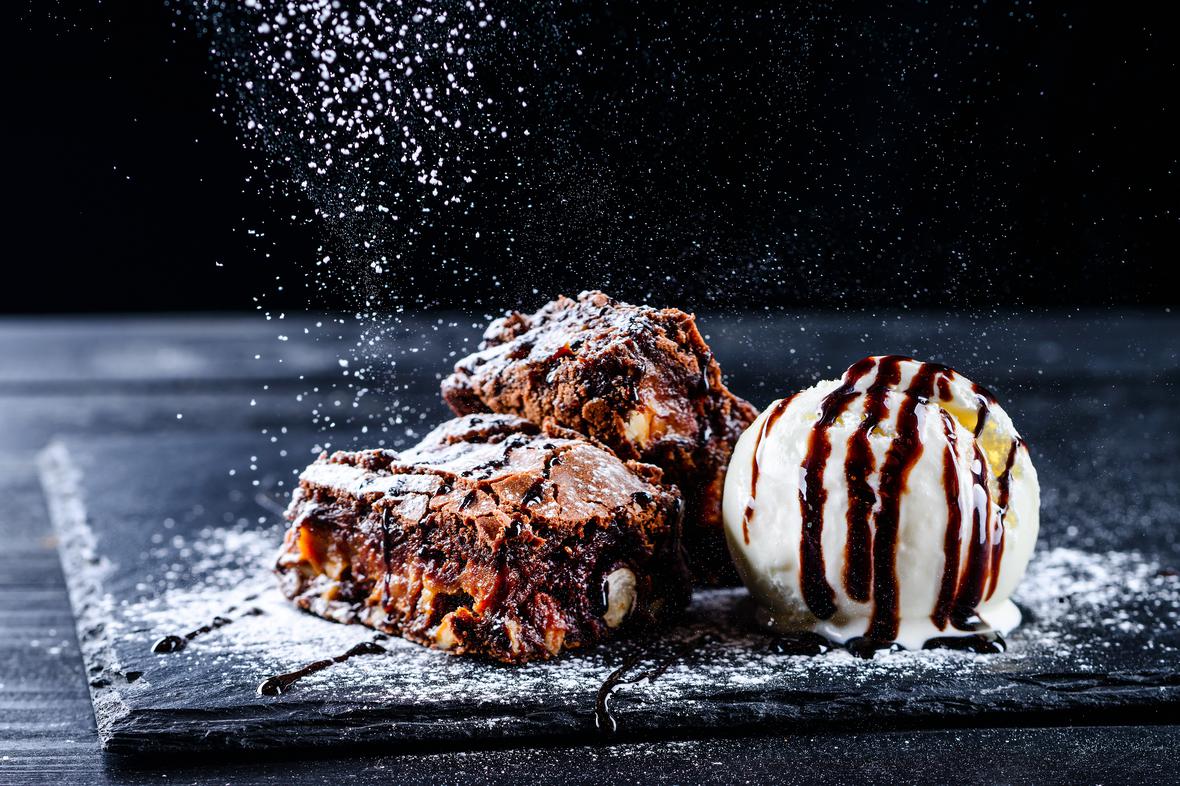 Indulgent, sugar-reduced dessert of hot brownies with ice cream