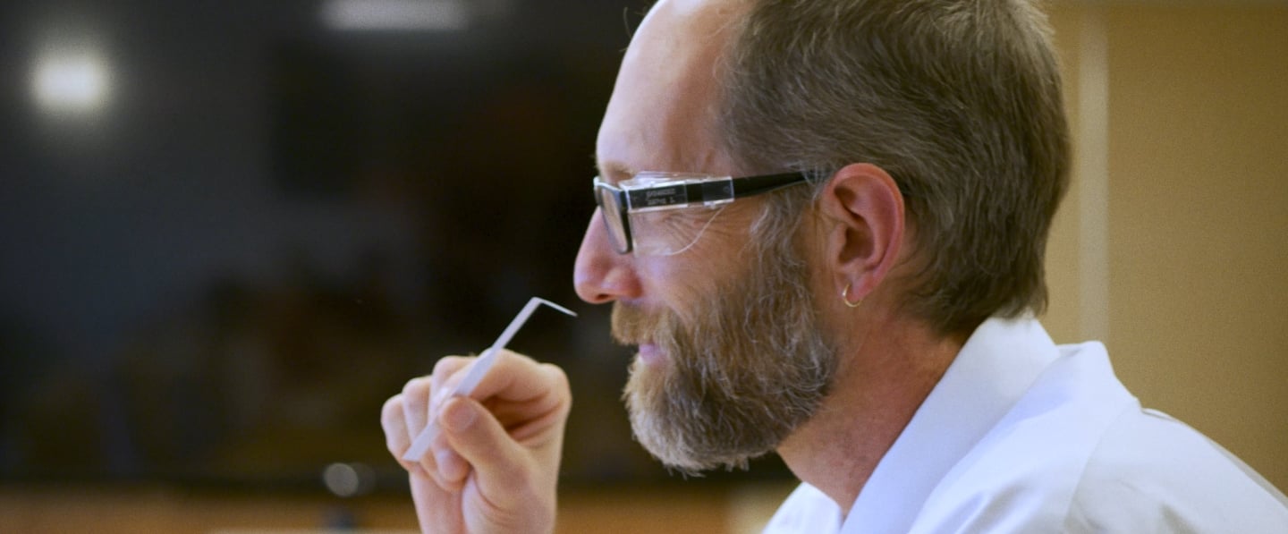 Bearded scientist tasting ADM flavor solutions
