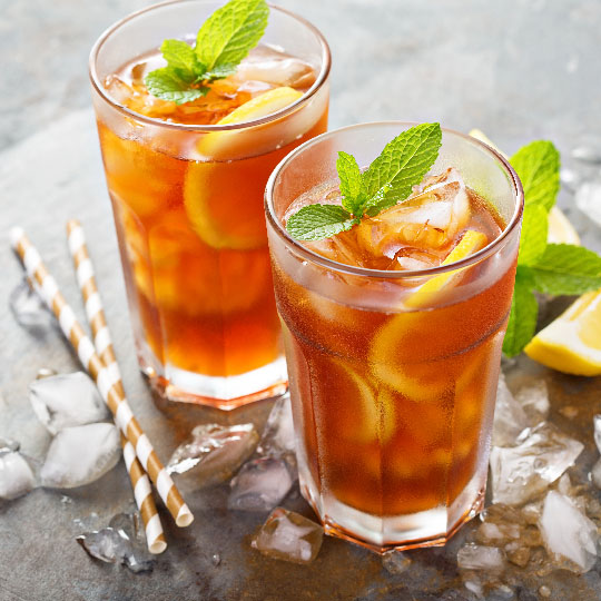 Flavorful and colorful beverages with oranges, mint on a grey table background