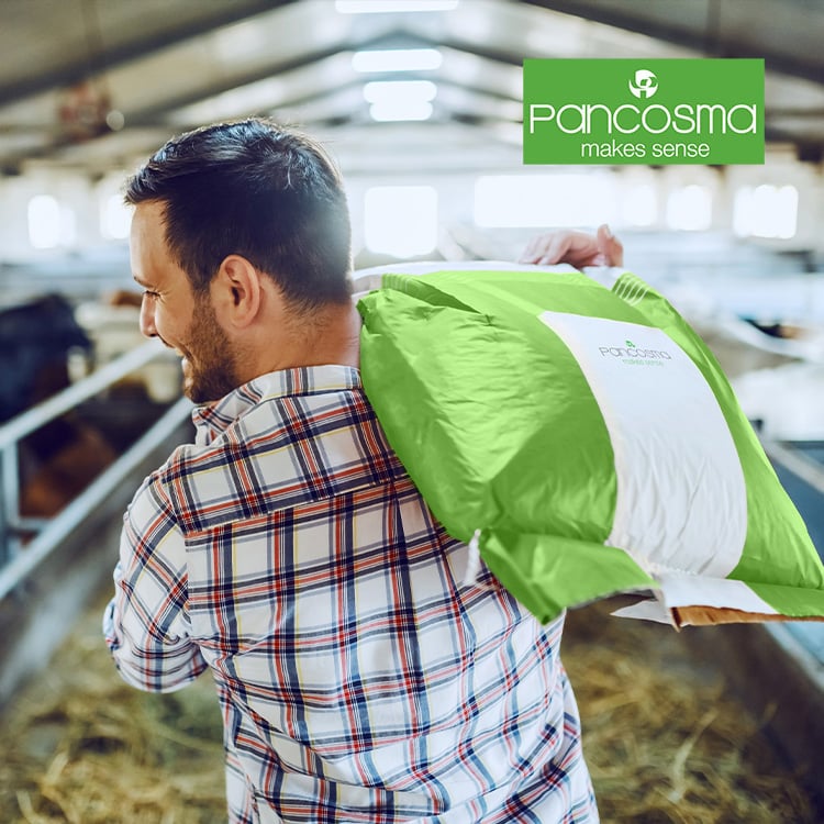 farmer feeding his animals with Pancosma  