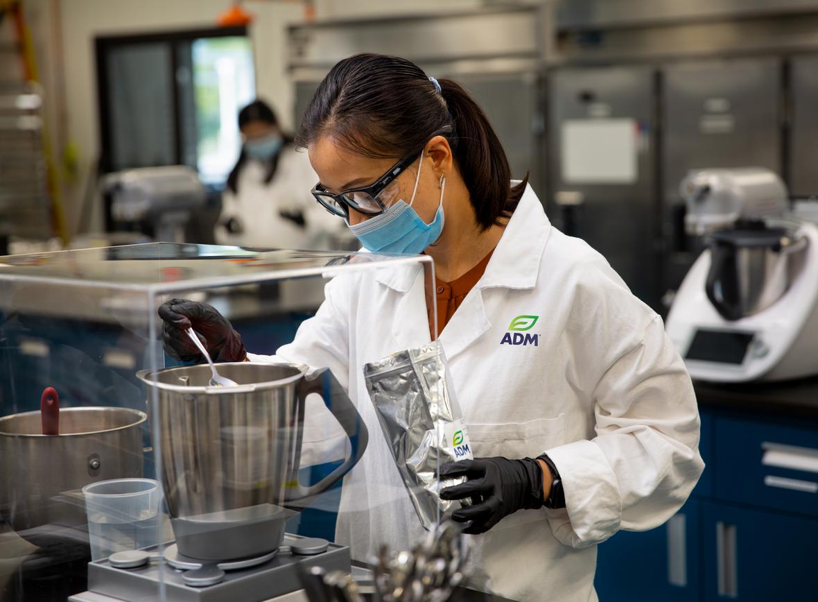 Women mixing ingredients in a blender