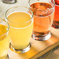 Cider glasses with many shades of yellow on an inviting table