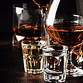 Close up of spirits poured in glasses on a dark background