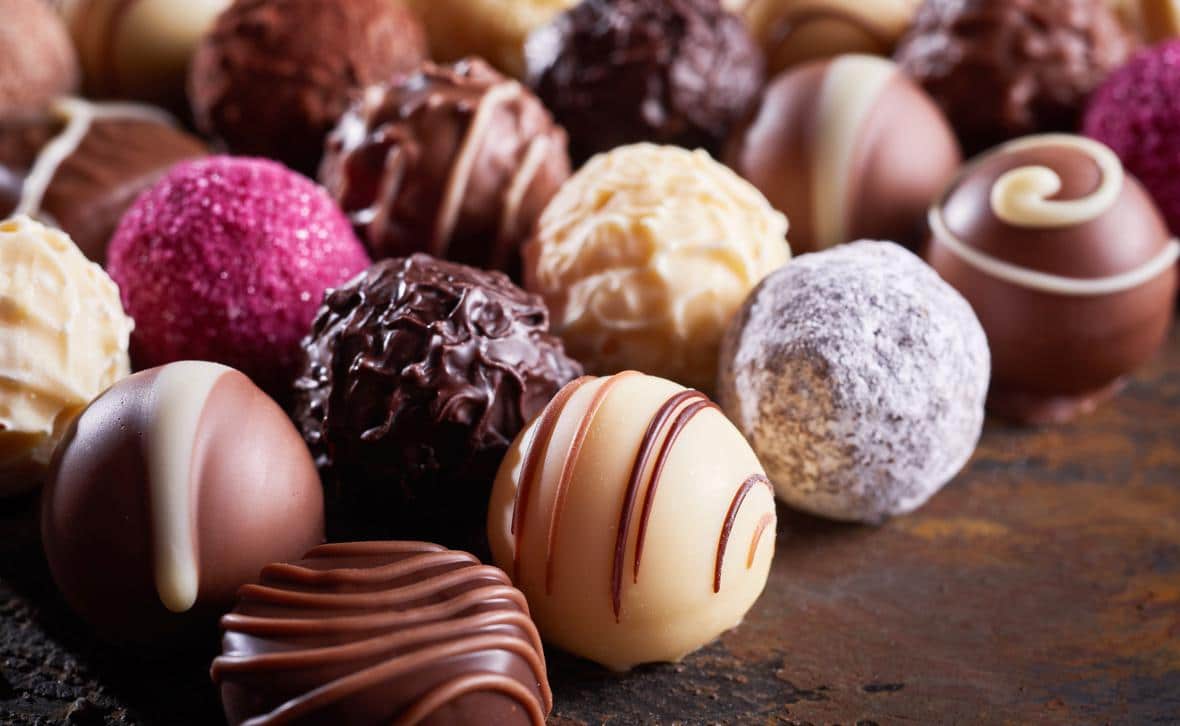 Rows of multi-coloured round chocolates
