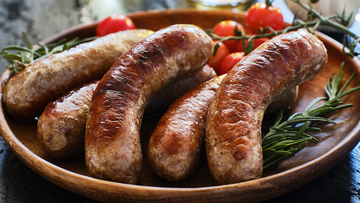 Sausages on a brown plate