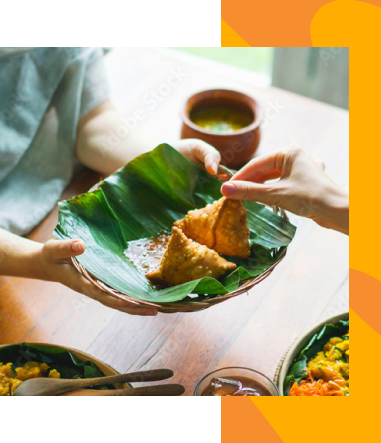 Samosa is being served from a leafy plate