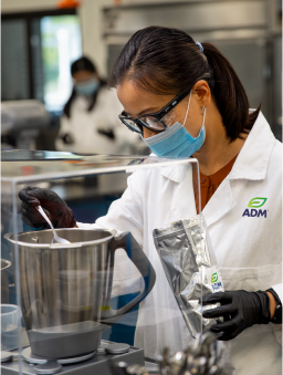 A female food scientist mixing a formula in her laboratory.