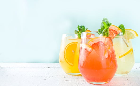Three beverages infused with orange, lemon, grapefruit, lime, and other fresh citrus fruit juice