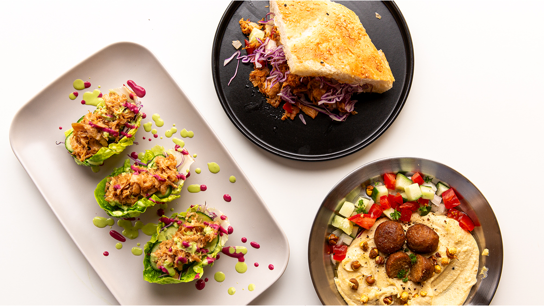 Several plates of food on a white surface