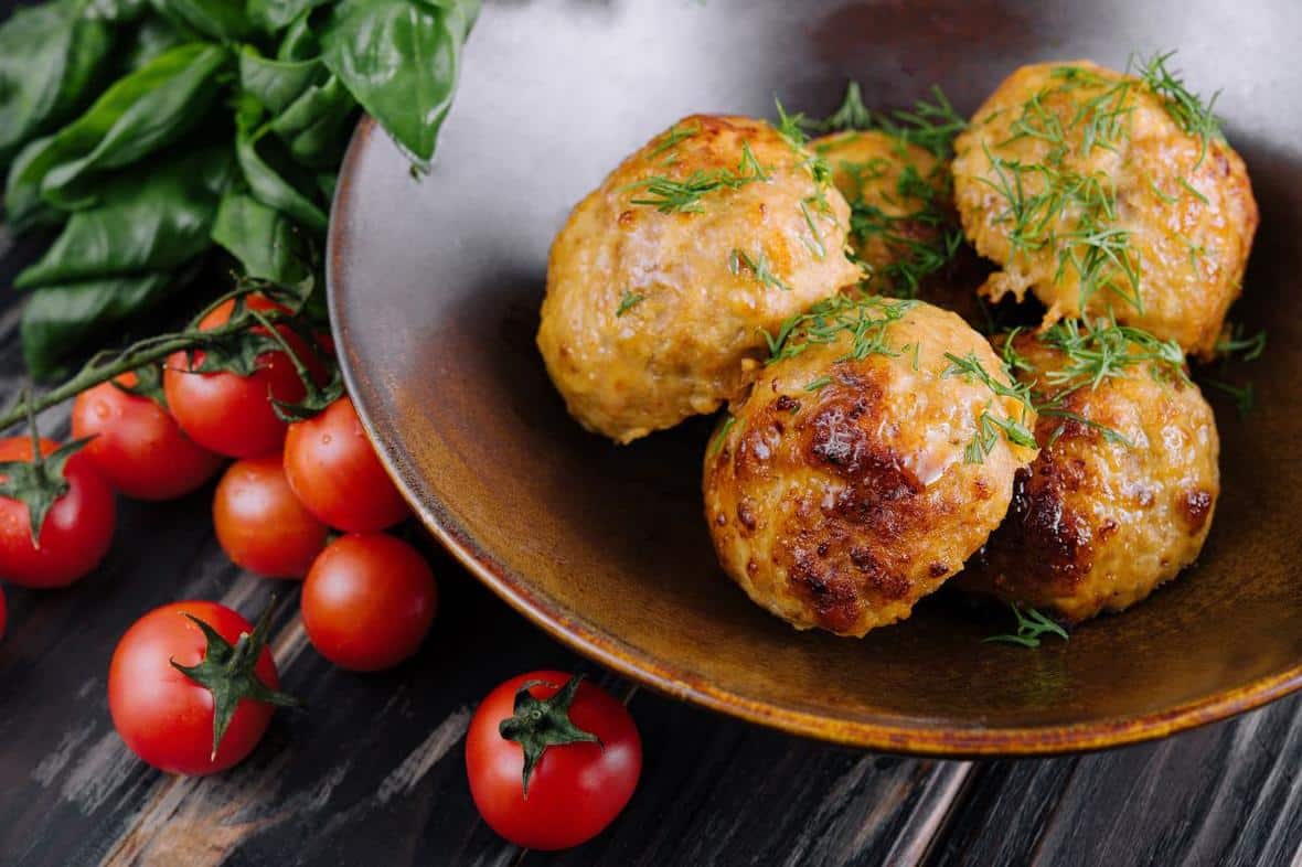 ADM Plant based meatballs decorated with salad and tomatoes on a table