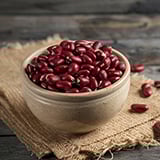 A bowl of red beans on top of burlap cloth