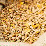 A close-up of a sack of brown pellets