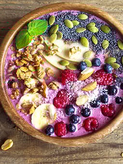 An acai bowl with fruit and nuts