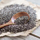 A wooden spoon in a pile of chia seeds