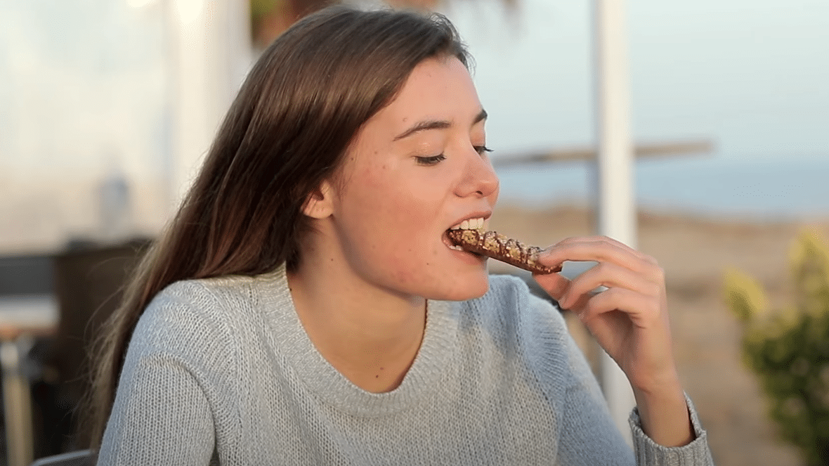 girl eating grain bar