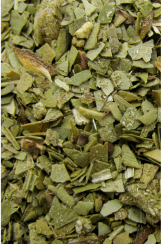 A close-up of a pile of green leaves of botanical extracts