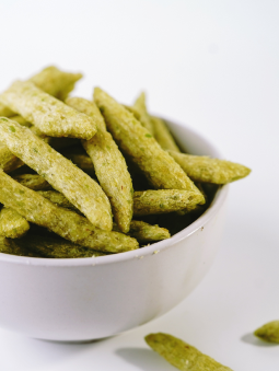 Green snap pea crisp snacks in a white bowl