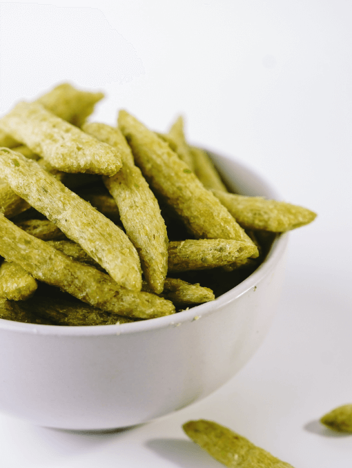 Green snap pea crisp snacks in a white bowl 