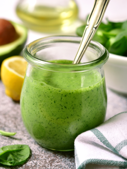 A jar of bright green pesto sauce