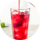 A glass of red iced hibiscus tea made with a naturally derived color solution