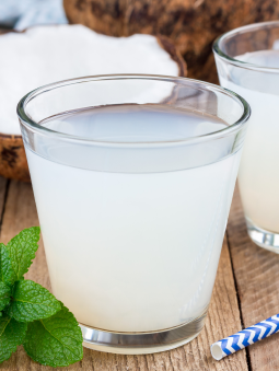 A cloudy coconut drink in a glass