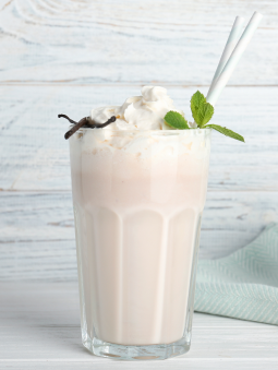 A glass of a vanilla milkshake