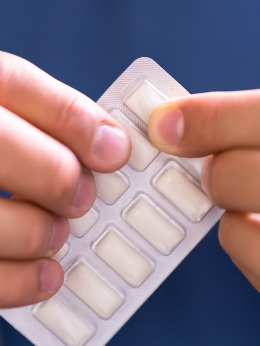 A close-up of someone opening a pack of gum