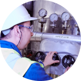 Factory worker looking at production of oils