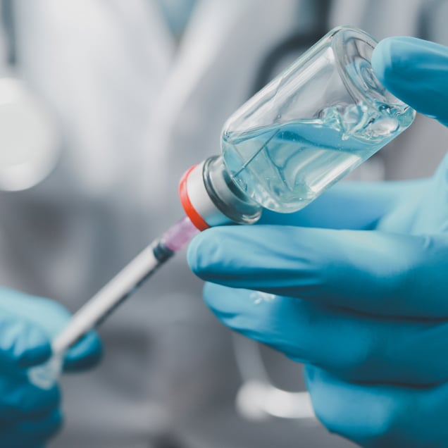 A close-up of a syringe being filled with liquid