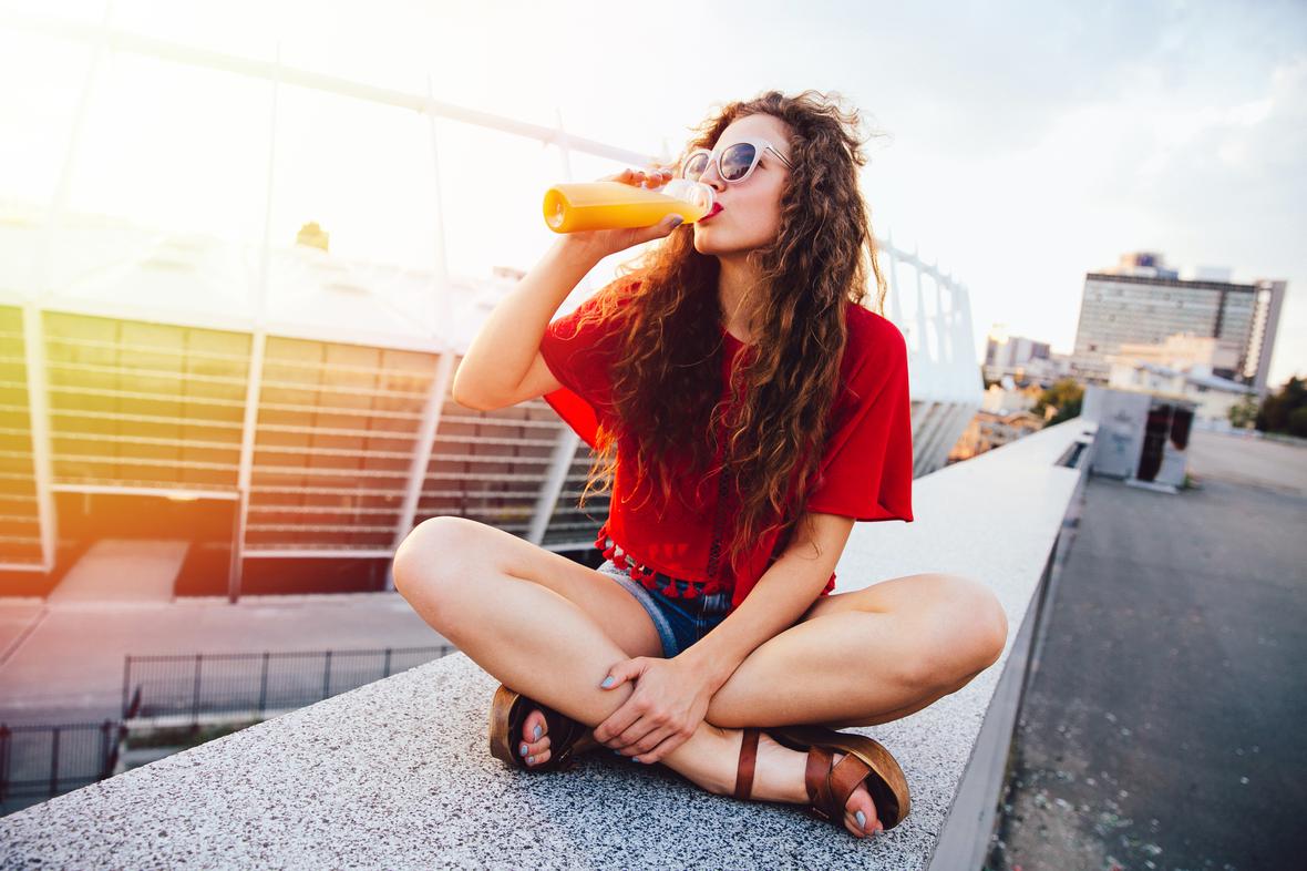 A woman drinking fresh juice