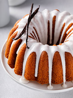 Vanilla bundt cake drizzled with powder sugar glaze