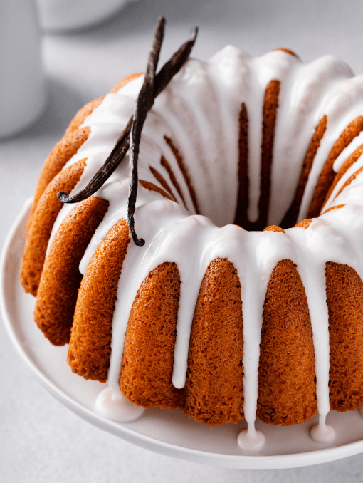 Vanilla bundt cake drizzled with powder sugar glaze