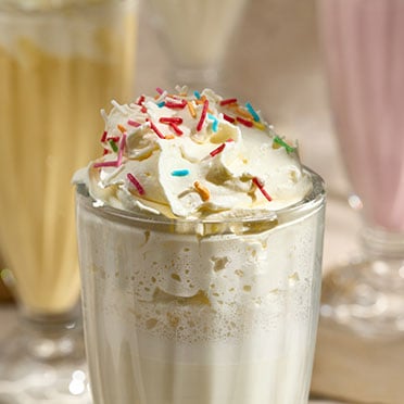 A close up of a vanilla milkshake