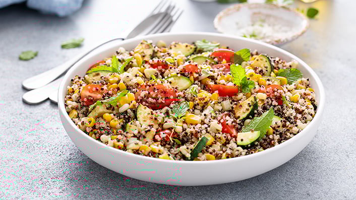 A white bowl with ancient grains and vegetables