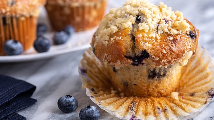 A blueberry muffin made with whole wheat flour