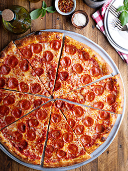 A sliced pepperoni pizza with a whole wheat flour crust